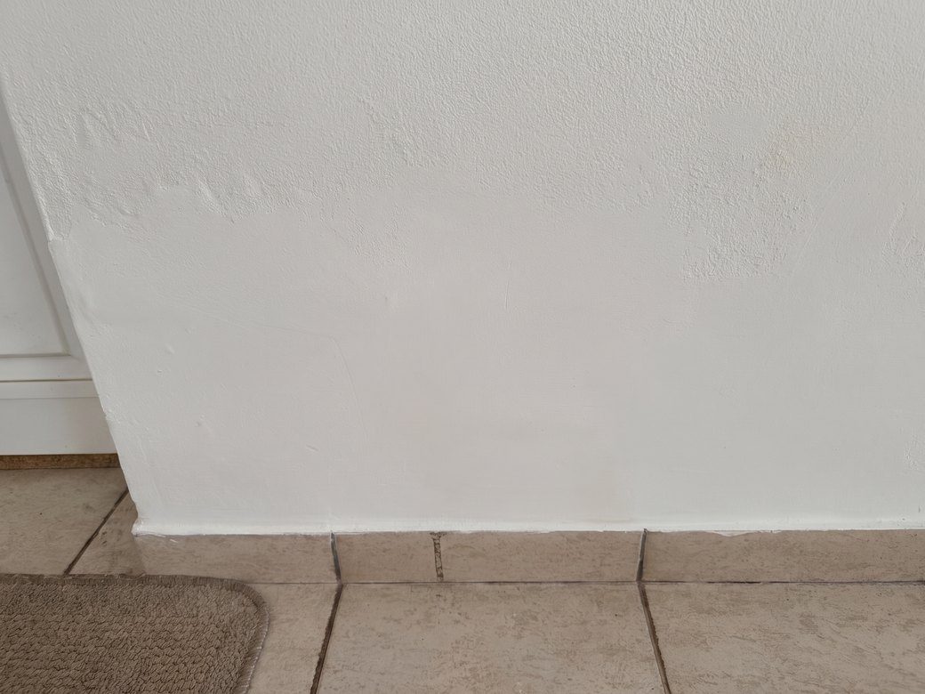 The same wall after replastering and redecoration, clean and dry